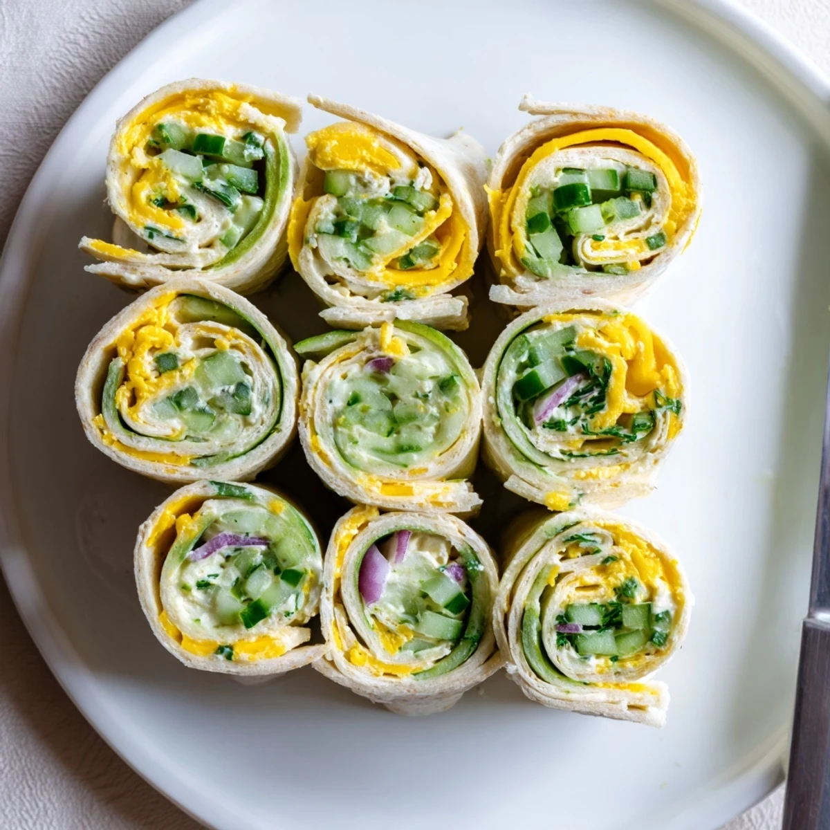 Crispy dill pickles wrapped in tortillas with creamy cheese make a delightful Pickle-in-a-Blanket.