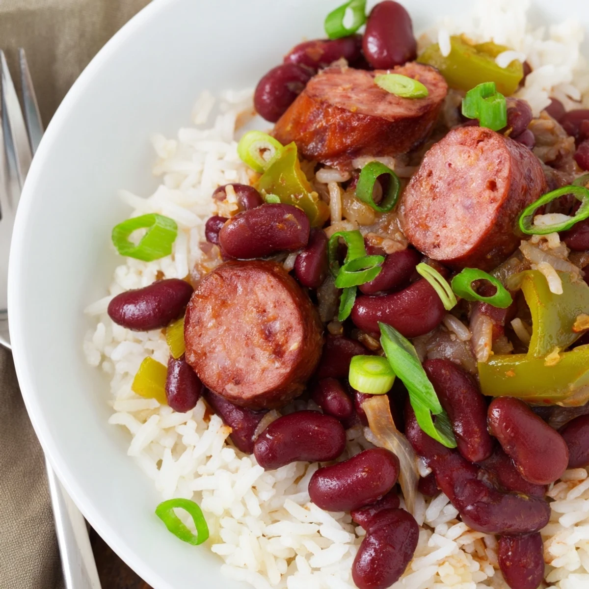 Hearty Red Beans & Rice with smoky sausage served over fluffy white rice.  
