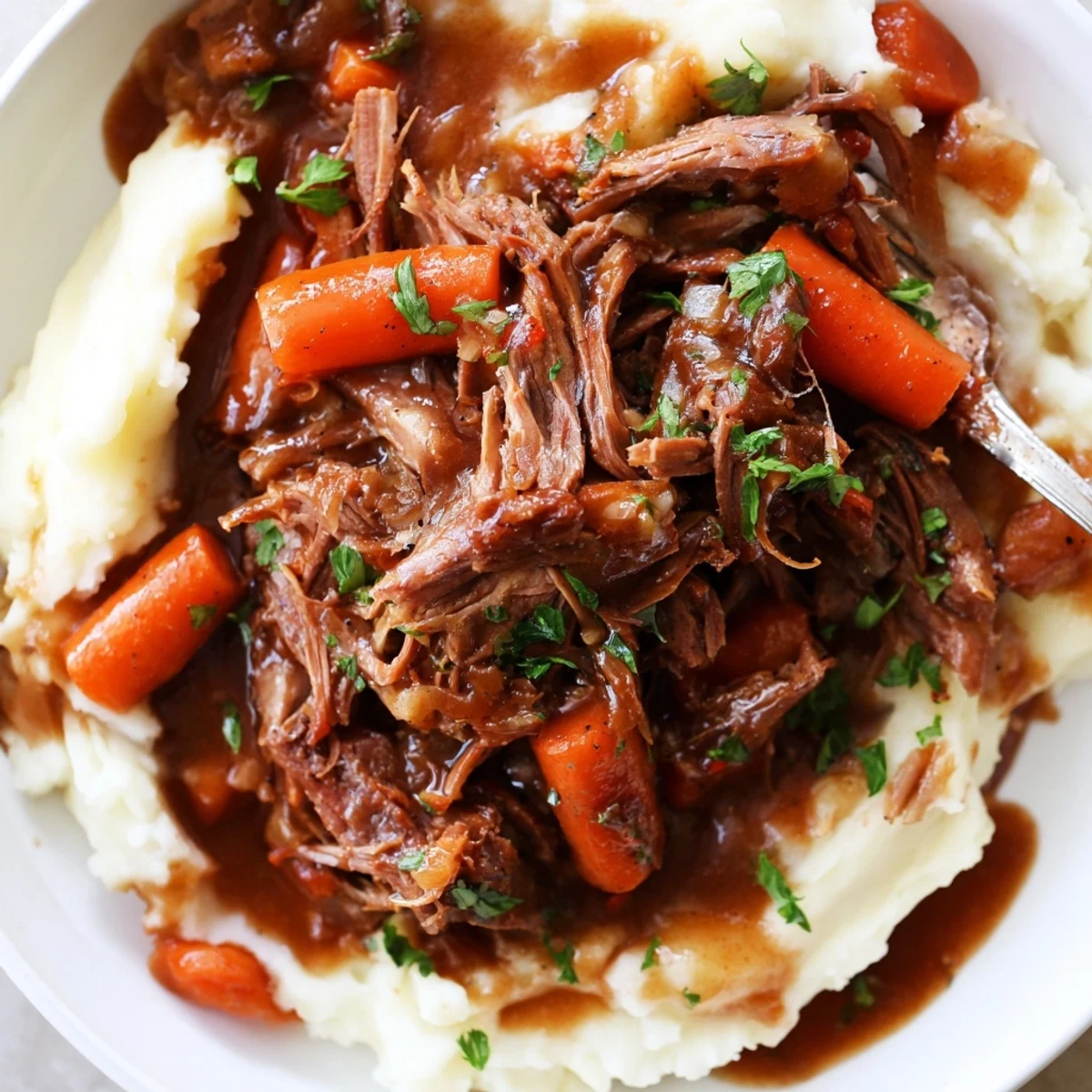 Slow Cooker Pot Roast with Mashed Potatoes served on a rustic plate with gravy.  