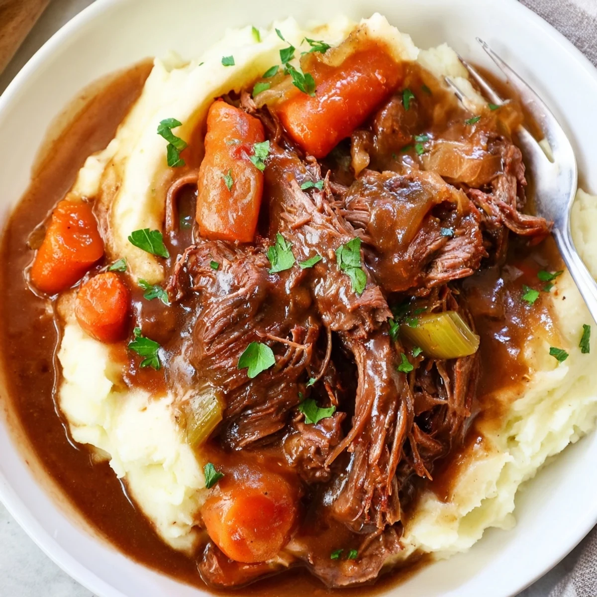 Tender Slow Cooker Pot Roast nestled among vibrant vegetables, paired with creamy mashed potatoes.  