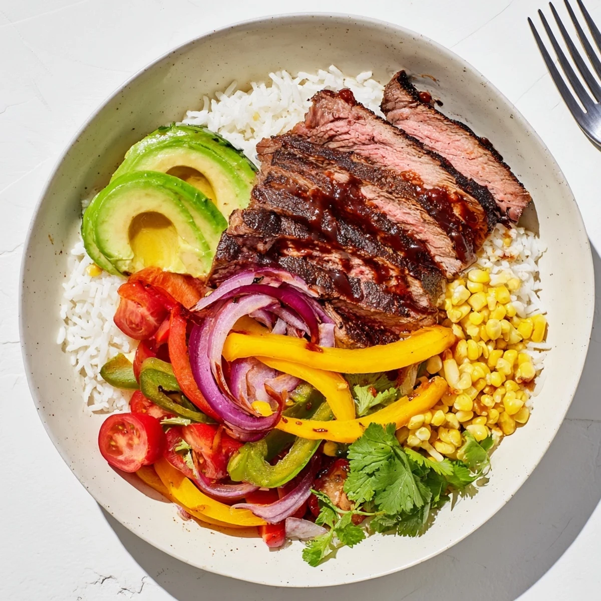 Vibrant BBQ steak fajita bowl with sizzling steak, colorful peppers, and fluffy rice, tastes fantastic!