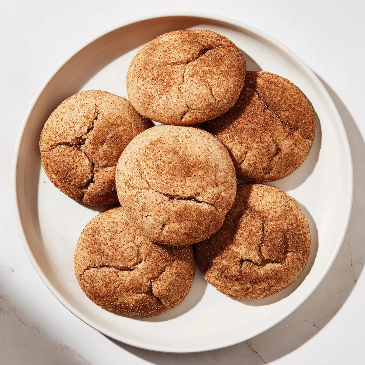 A stack of warm, chewy soft molasses cookies, dusted with sugar, perfect for dessert.