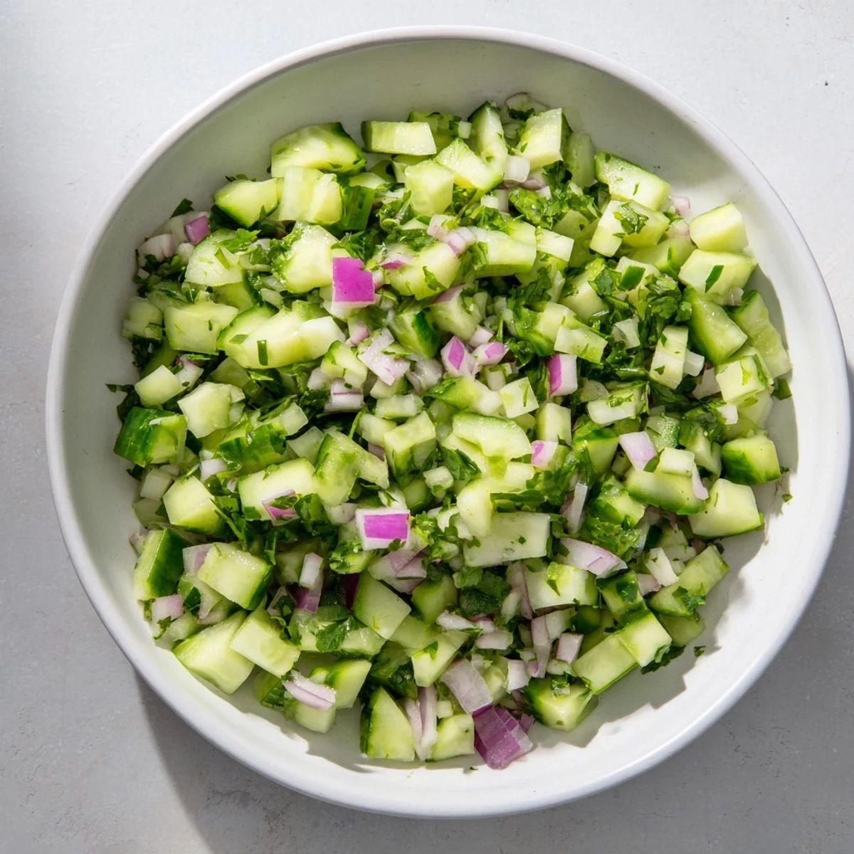 Fresh Simple Cucumber and Dill Chopped Salad, a vibrant mix with bright green cucumber glistening in dressing.
