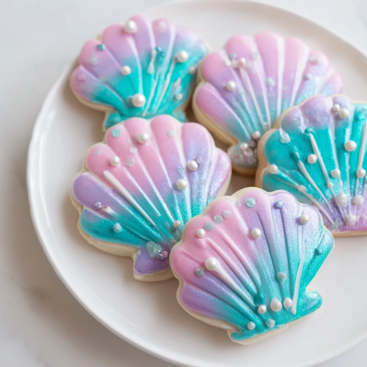 Vibrant pastel Seashell Sweets, decorated with edible pearls, look sweet and enchanting for a party.