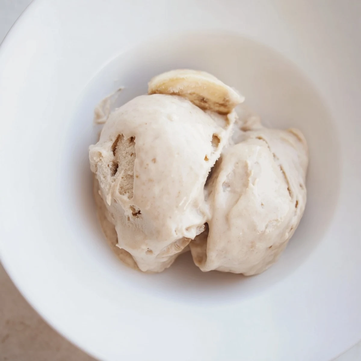 Creamy 2-Ingredient Banana Ice Cream, served cold and swirled, perfect for a summer dessert.