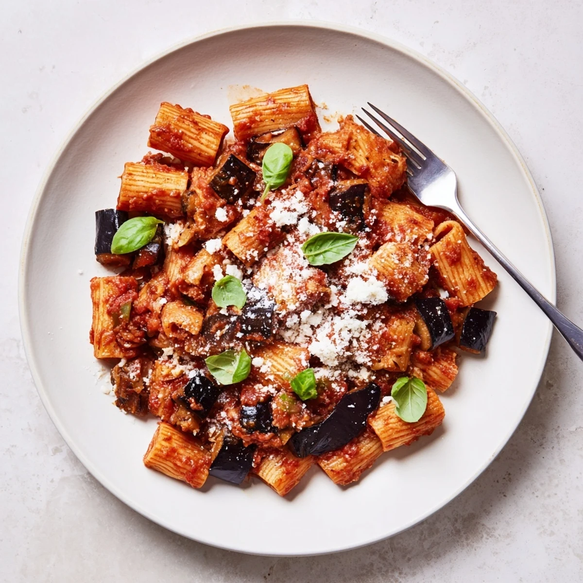 Tender roasted eggplant pieces nestled in rigatoni with a vibrant tomato sauce in Pasta Alla Norma.  
