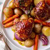 Close-up of glistening Sheet Pan Hot Honey Mustard Chicken, ready to serve friends.