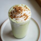 Creamy Sugar-Free Gingerbread Cookie Matcha Frappe, garnished with whipped cream and spices, looks refreshing.