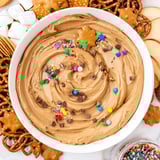 Sweet Gingerbread House Dip, a delicious dessert served on a large wooden board with goodies.