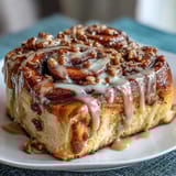 Decadent Cinnamon Roll Pancake Casserole with cream cheese glaze, baked until golden and swirled with cinnamon sugar.