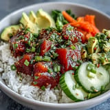 Quick canned tuna poke bowl featuring colorful veggies and fluffy seasoned rice.