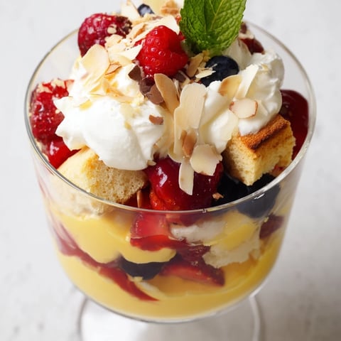 Simplified Christmas Trifle Cups showcasing layers of fluffy cake, fresh berries, and whipped cream, ready to serve!