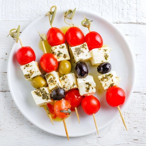 Holiday Cheers Olive and Feta Skewers arranged on a platter, ready to be enjoyed with olives and tangy feta cheese.