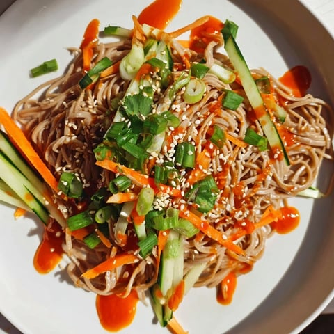 Bright chilled noodle lunch cups with vibrant cucumbers and carrots, ready to eat.