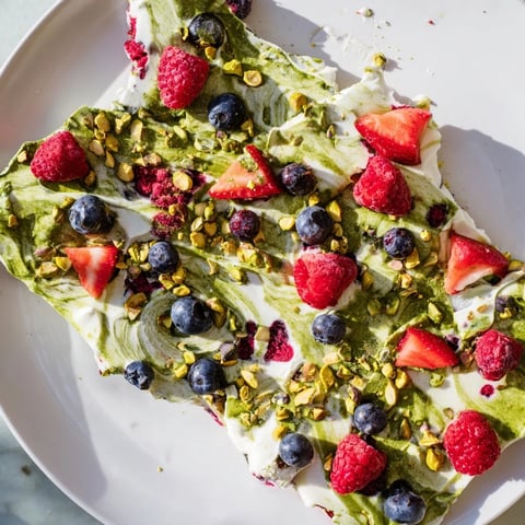 Creamy frozen yogurt bark swirled with matcha and fresh berries, a delightful, easy frozen treat.