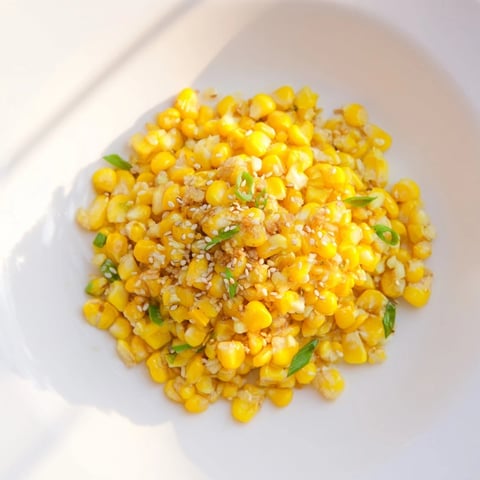 Golden kernels of Japanese Butter Corn glistening with savory sauce, ready for serving as a side.