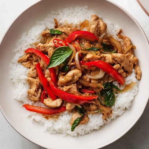 Thai Basil Chicken Bowls with vibrant red peppers and fragrant holy basil, ready to eat!