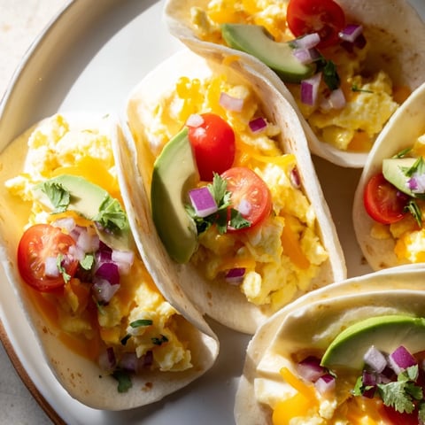 Sheet Pan Breakfast Tacos loaded with melted cheese, fresh toppings, served with salsa.