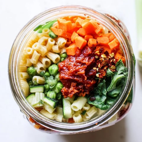 Layered colorful Minestrone Soup in a jar, ready to add water and quickly warm for a satisfying meal.