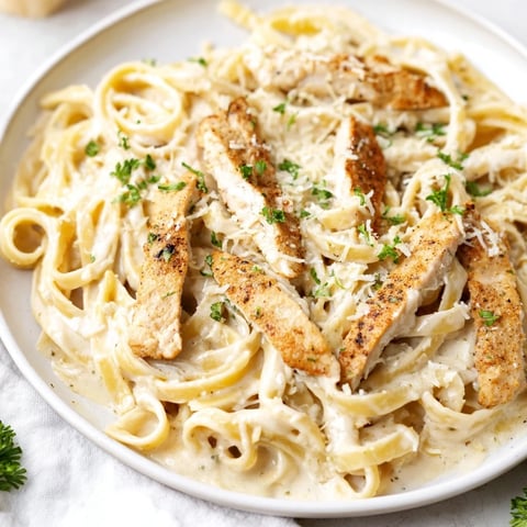 Skillet Chicken Alfredo, a creamy, golden dish with tender chicken and Parmesan cheese.