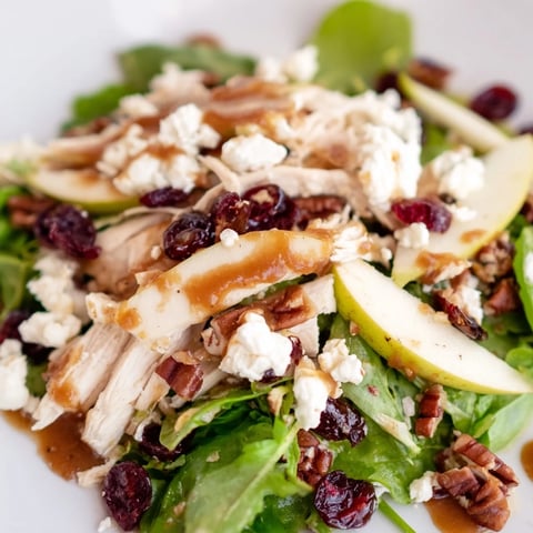 A close-up of Caramel Apple Chicken Salad showing tender chicken slices, crisp apples, and greens tossed in caramel-pecan dressing.  