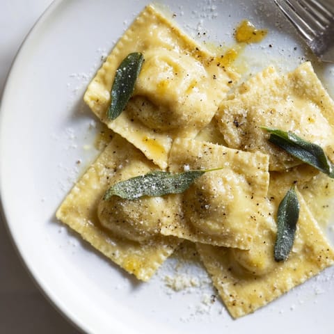 Homemade Sage Butter Pumpkin Ravioli: plump pasta pillows in a rich, nutty sauce.