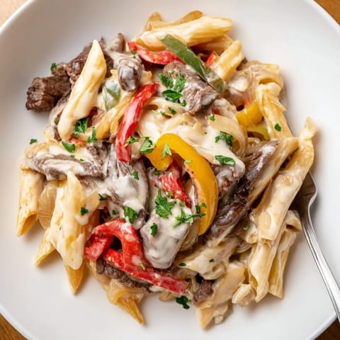 Deliciously creamy Philly Cheese Steak Pasta served in a warm, hearty bowl.  