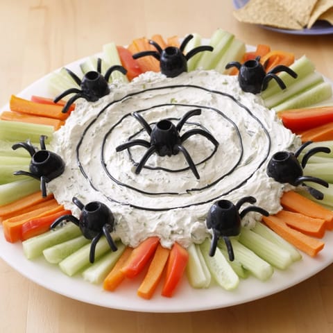A creamy Creepy Crawly Spiderweb Platter is perfect for a spooky Halloween appetizer spread.