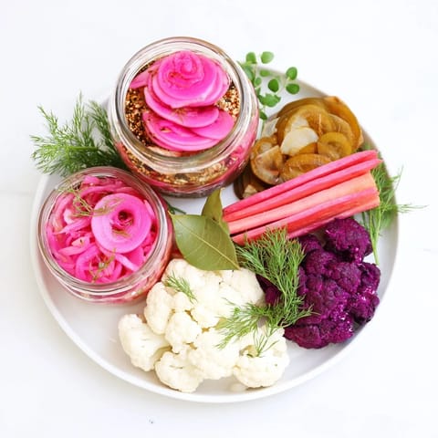 A vibrant close-up of the Pickled & Fermented Feast showcases colorful pickled vegetables and herbs, ready to be enjoyed.