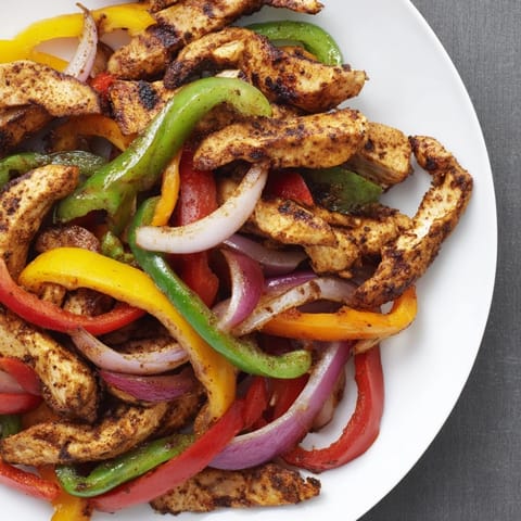 Golden-brown Sheet-Pan Chicken Fajitas, fragrant from the oven and ready for your tortillas.