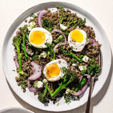 French Lentil Salad With Broccolini and Soft-Cooked Eggs served over a bed of greens with a tangy Dijon vinaigrette.  