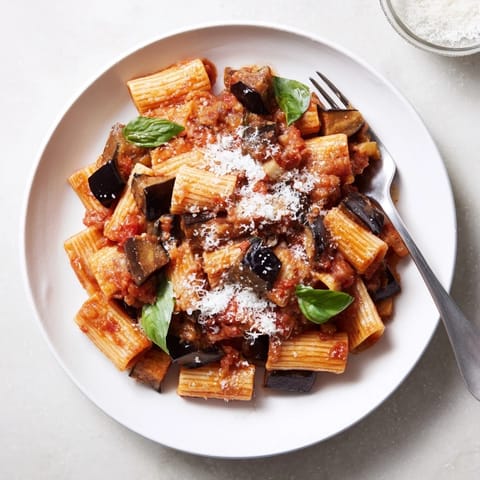 Golden eggplant cubes and rich tomato sauce tossed with pasta, topped with crumbly ricotta salata.  