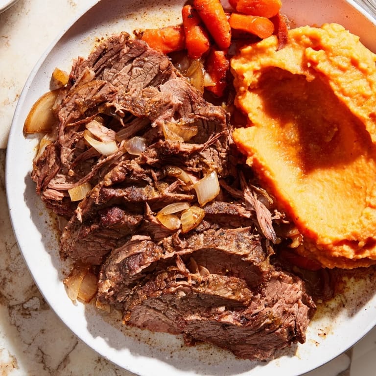 A close-up shot of rich, savory Classic Brisket & sweet potatoes; a hearty American dish.