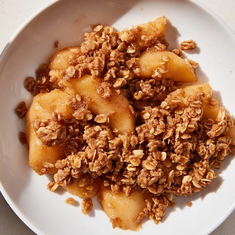 Golden-brown crisp topping covers baked Apple Crisp, a simple and satisfying American dessert.