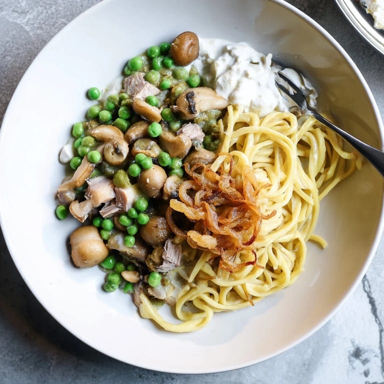 This delicious image shows a family-style Tuna Noodle Casserole crowned by a delightful, crunchy onion layer.
