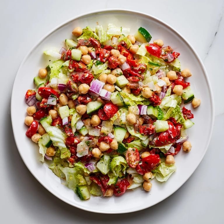 A delicious serving of La Scala Chopped Chickpea Salad, featuring fresh ingredients and a zesty Italian dressing; a perfect lunch.
