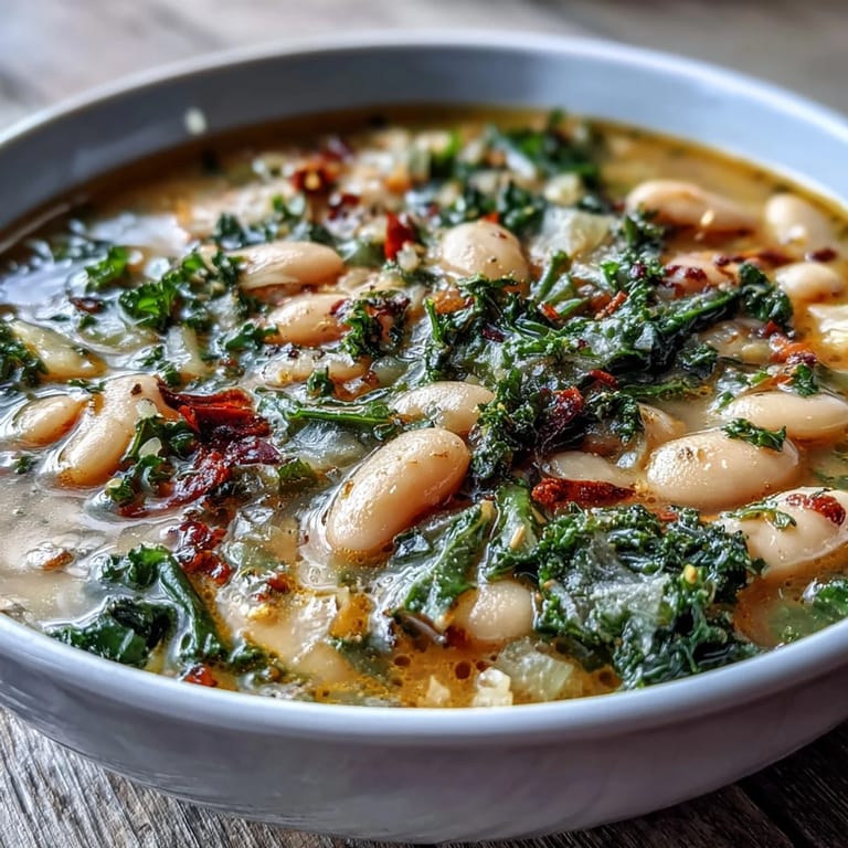 Creamy cannellini beans and tender kale in a rustic Italian soup, brightened with fresh lemon zest and served with crusty bread.
